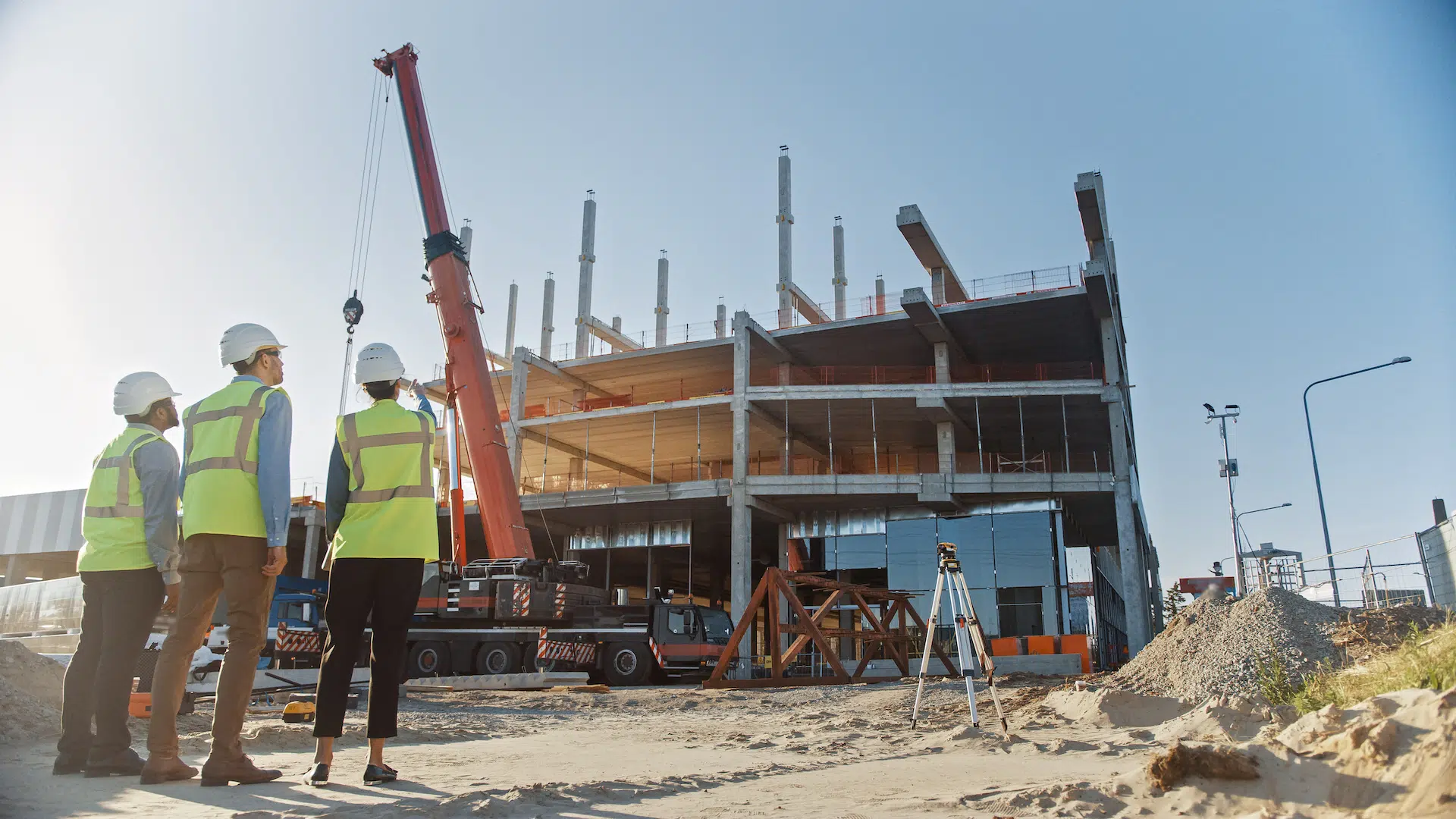 A construction worker standing in front of a building.